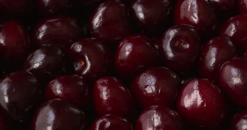 Sweet cherries full frame background texture with window reflections rotating. Stock Footage 342276935