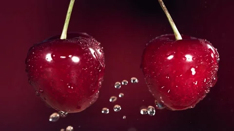 Sweet Cherries on Stems Colliding and Splashing Water Droplets in Slow Motion Stock Footage 199130554
