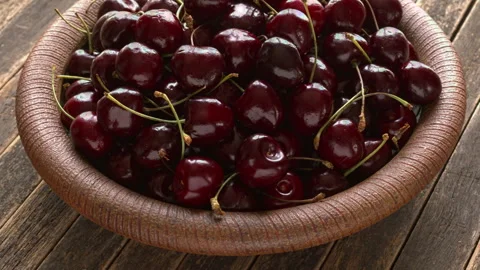 Sweet cherries with stems on handmade ceramic plate. Stock-Footage 342848635