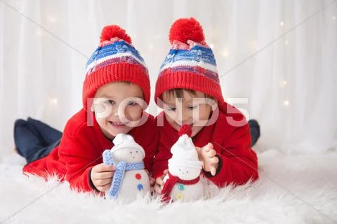 Sweet children, brother boys, playing with handmade snowmen at home Stock Photos