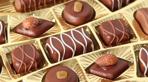 Sweet chocolates in golden box turn around Stock Footage