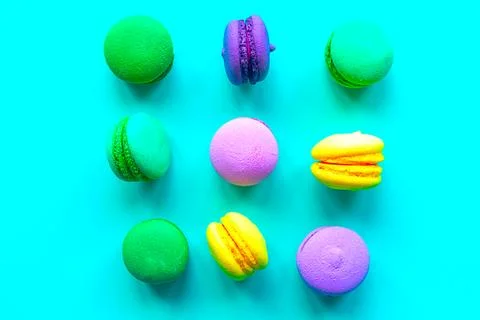 Sweet color macaroons on green background. Flat lay, top view Stock Photos