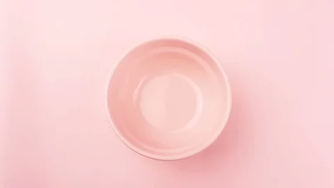 Sweet color macaroons or macaron in pink plate on pastel surface. Close up. Stock Footage