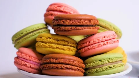Sweet color macaroons on plate. Macro close up. Slide from right to left. Stock Footage 106985108