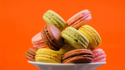 Sweet color macaroons on red background. Slide from right to left Stock Footage 106984416