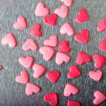 Sweet colorful candy hearts background Stock Photos