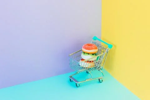 Sweet colorful donuts in supermarket trolley Stock Photos