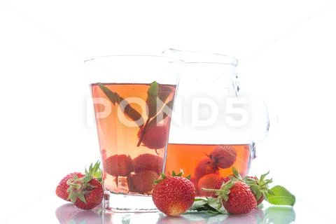 Sweet compote of ripe red strawberries in a glass decanter Stock Photos