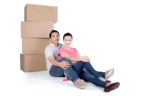 Sweet couple with stack of cardboard boxes 写真素材