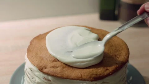 Sweet cream being applied to a cake sponge layer, cake decoration and assem.. Stock Footage 302099731