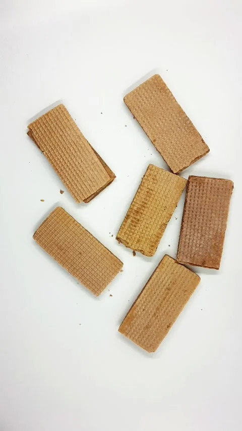 Sweet crispy rectangular wafer cookies with filling on white background Video stock 329363399