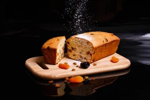 Sweet cupcake in the shape of bread. Cupcake with raisins, dried apricots, plums Stock Photos