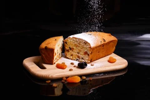 Sweet cupcake in the shape of bread. Cupcake with raisins, dried apricots, plums Stock Photos