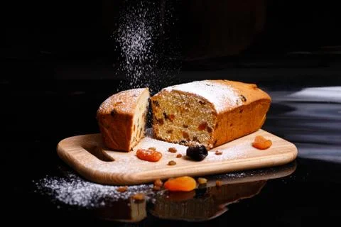 Sweet cupcake in the shape of bread. Cupcake with raisins, dried apricots, plums Stock Photos