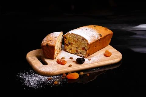 Sweet cupcake in the shape of bread. Cupcake with raisins, dried apricots, plums Stock Photos