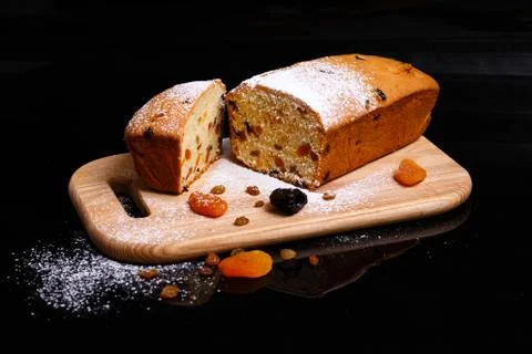 Sweet cupcake in the shape of bread. Cupcake with raisins, dried apricots, plums Stock Photos