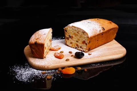 Sweet cupcake in the shape of bread. Cupcake with raisins, dried apricots, plums Stock Photos