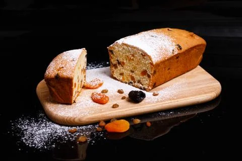 Sweet cupcake in the shape of bread. Cupcake with raisins, dried apricots, plums Stock Photos