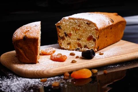 Sweet cupcake in the shape of bread. Cupcake with raisins, dried apricots, plums Stock Photos