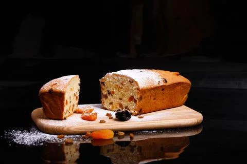 Sweet cupcake in the shape of bread. Cupcake with raisins, dried apricots, plums Stock Photos