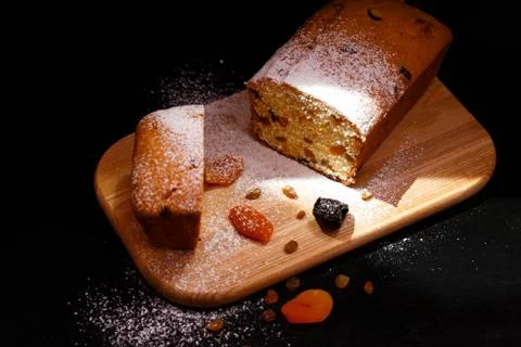 Sweet cupcake in the shape of bread. Cupcake with raisins, dried apricots, plums Stock Photos