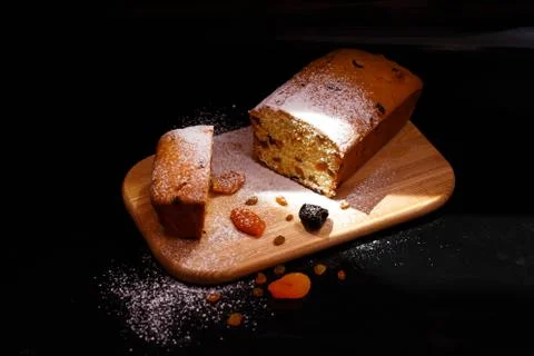 Sweet cupcake in the shape of bread. Cupcake with raisins, dried apricots, plums Stock Photos