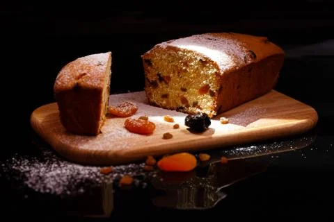 Sweet cupcake in the shape of bread. Cupcake with raisins, dried apricots, plums Stock Photos