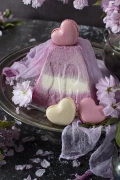 Sweet curd orthodox easter on a background of purple sakura, heart-shaped cakes Stock Photos