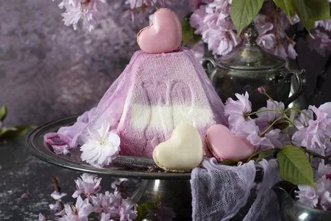 Sweet curd orthodox easter on a background of purple sakura, heart-shaped cakes Stock Photos