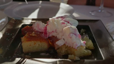 Sweet Desert consisting of Cake with honey and Raspberry ripple ice-cream Stock Footage 308990530