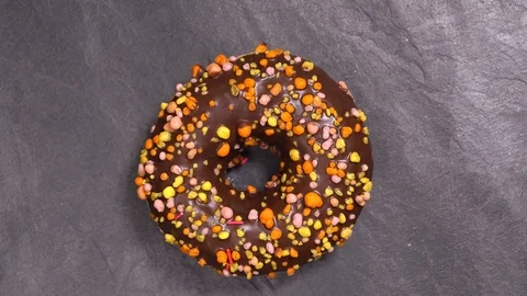 Sweet donut rotates on a dark background. Traditional American sweetness Stock Footage 103089334