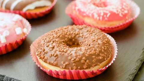 Sweet donuts on the black background Video stock 73601993