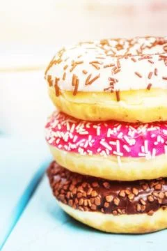 Sweet donuts on blue table Stock Photos