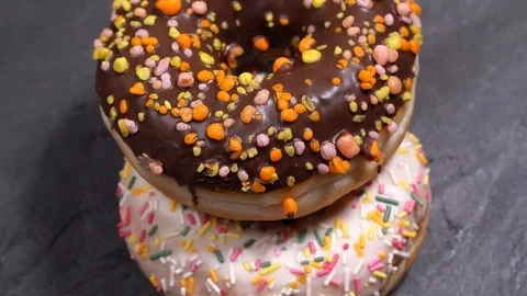 Sweet donuts spinning on a dark background. Traditional American sweetness Stock Footage 103092685