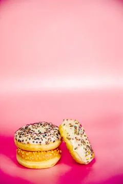 Sweet donuts stacked in a stack on a pink background. Copy space, various glaze Stock Photos