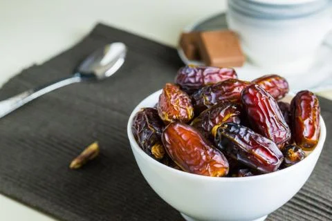 Sweet dried dates fruit in small bowl Stock Photos