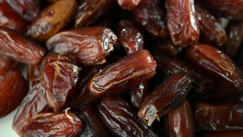 Sweet Dried Dates Spinning on Dark Surface. Top-Down Seamless Loop, Natural Stock Footage 325740803