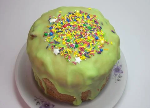 Sweet Easter cake, green melted sugar glaze topping with scattering of colo.. Stock Photos
