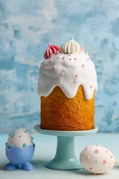 Sweet Easter cake with meringue and eggs on blue background Stock Photos
