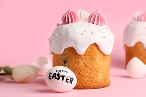 Sweet Easter cake with meringue, egg and tulip flower on pink background Stock-Fotos