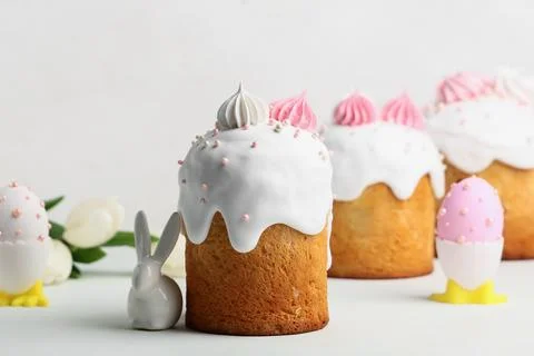 Sweet Easter cake with meringue, eggs and toy bunny on white background Stock Photos