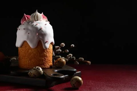 Sweet Easter cake with meringue, eggs and pussy willow branches on red table Stock Photos