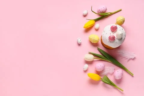 Sweet Easter cake with meringue, painted eggs and tulip flowers on pink backg Stock Photos