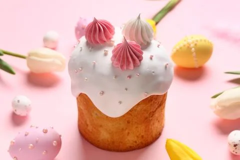 Sweet Easter cake with meringue, painted eggs and tulip flowers on pink backg Stock Photos