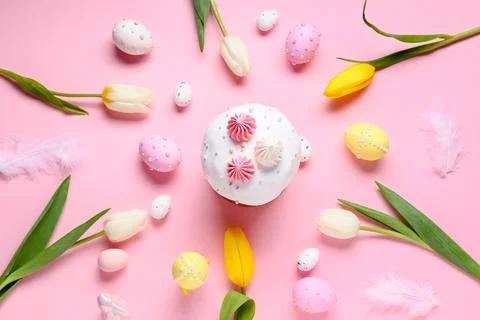 Sweet Easter cake with meringue, painted eggs and tulip flowers on pink backg Stock Photos