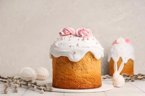Sweet Easter cakes with meringue, eggs, toy bunny and pussy willow branches o Stock Photos