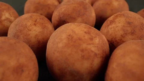 Sweet fragrant marzipans on a dark table. Marzipan potatoes. Recipe for Stock Footage 164632961