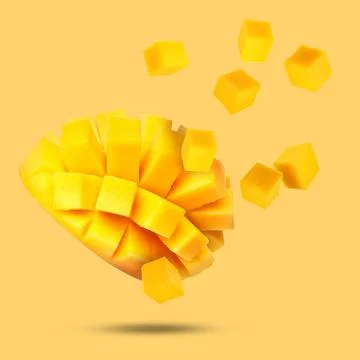 Sweet fresh mango cut in cubes falling on golden background Stock Photos