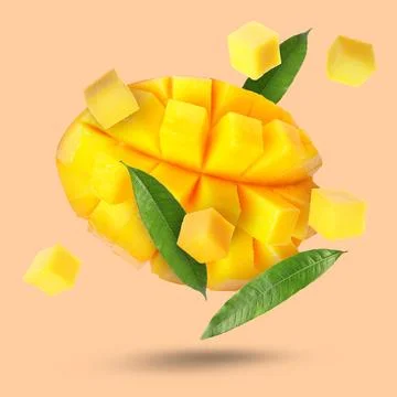 Sweet fresh mango cut in cubes falling on beige pink background Stock Photos
