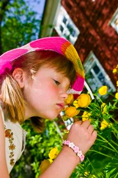 Sweet girl smelling flowers. Stock Photos